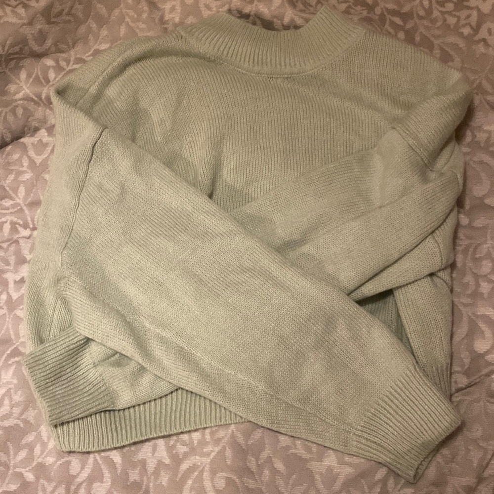 green cowl neck slightly cropped sweater. size M.